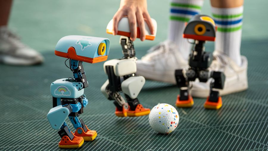 MicroDuck in action with a ball — one of the official launch photos from Pollen Robotics