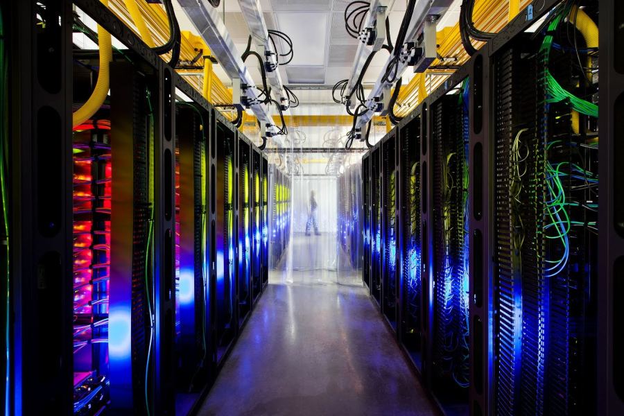 Server aisle inside a Google data center, illustrating the physical scale behind long-horizon agentic systems